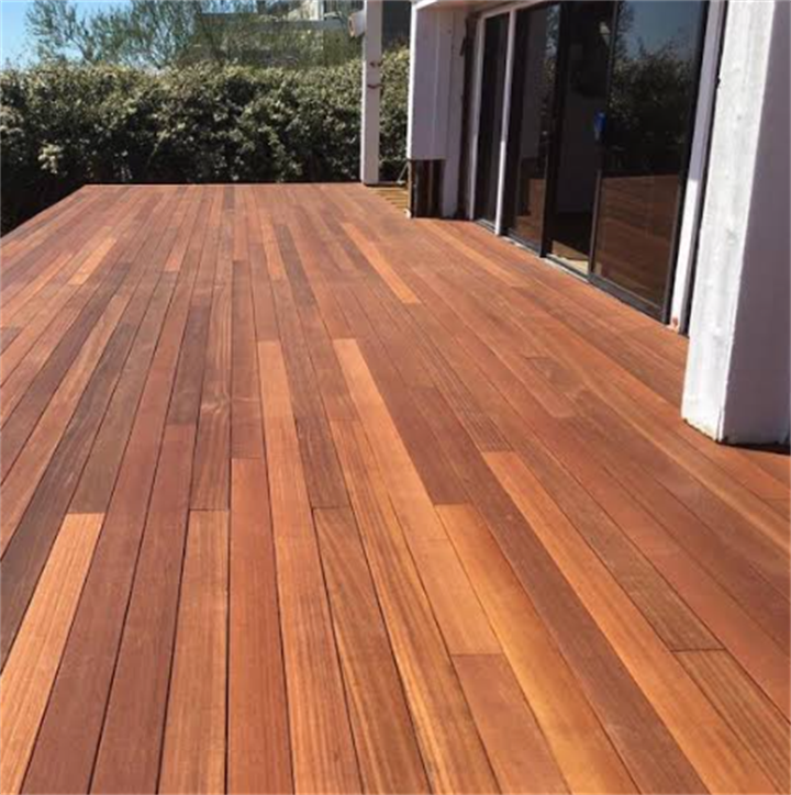 Spacious Brazilian teak hardwood deck attached to home with sliding patio doors