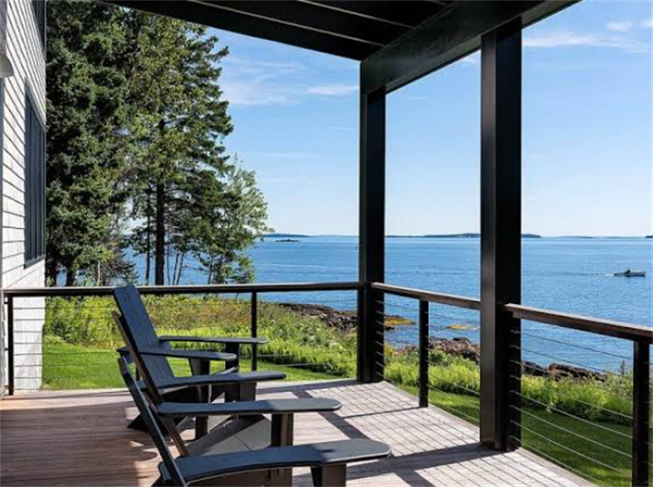 Modern low-maintenance composite deck on Maine rocky coastline, ideal to prevent wood tannin bleed